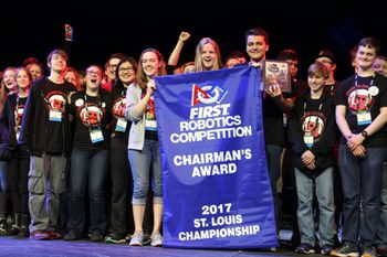 MARS team holding a flag for the Chairmen's Award in First Robotics Competition.